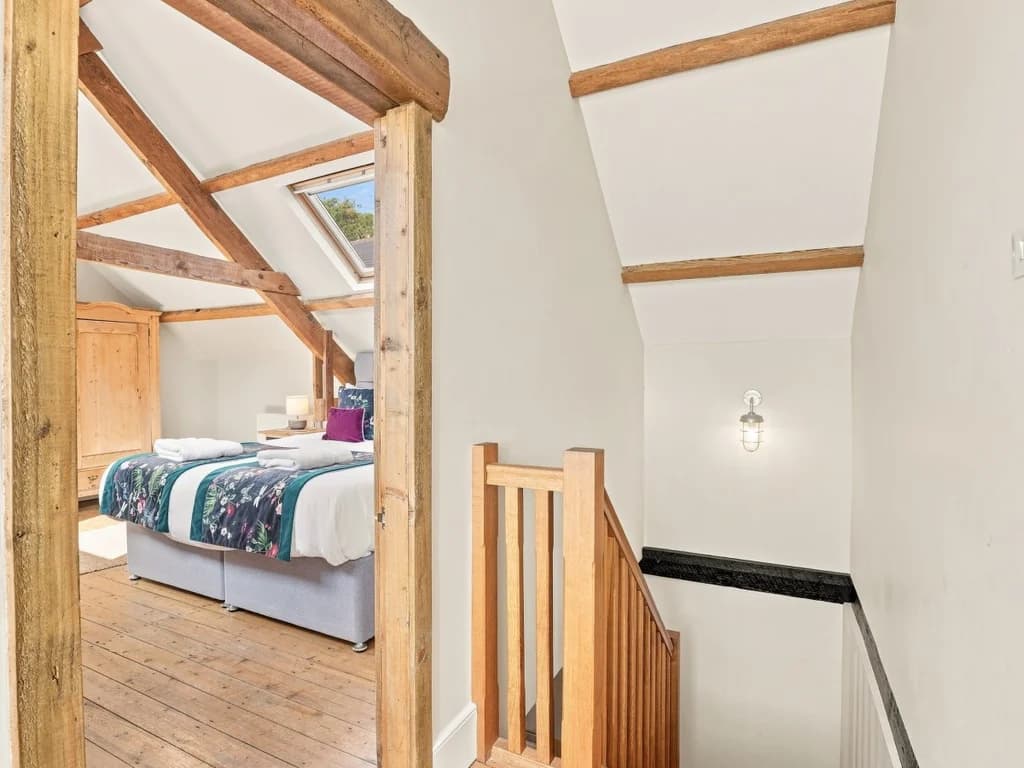 Upper-floor bedroom entrance with exposed timber beams