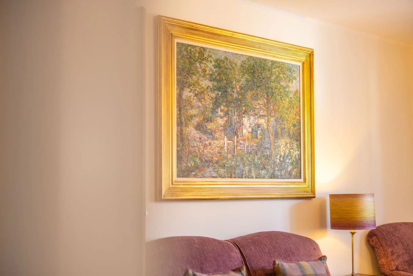 Framed landscape artwork above the lounge seating area