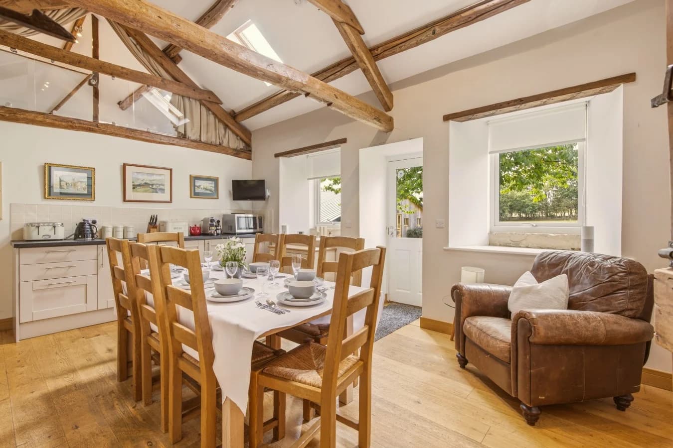 Open-plan kitchen and dining area beneath original timber beams
