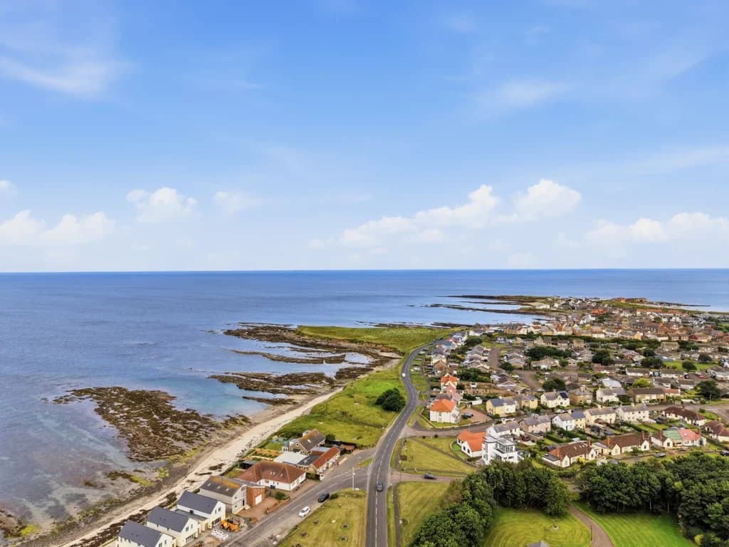 Elevated aerial view showcasing Beadnell Beach and the stunning coastline