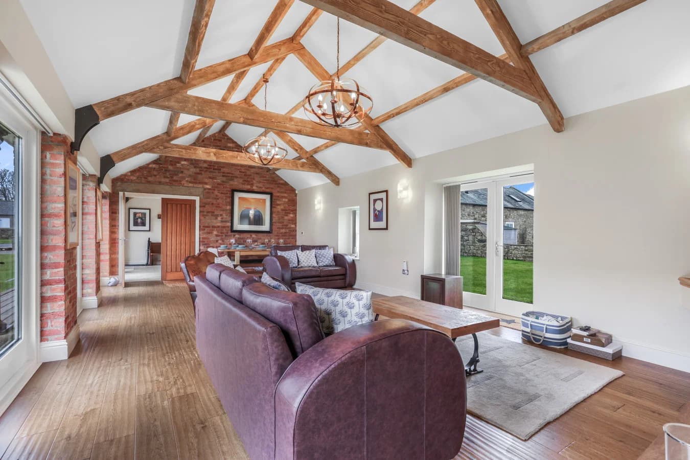 Open-plan living space with vaulted ceilings and exposed beams