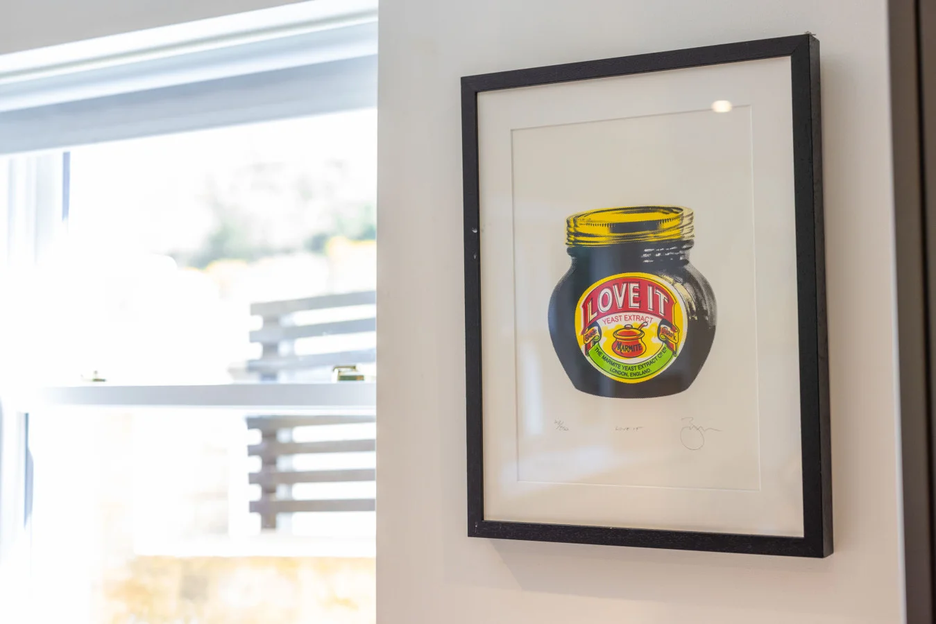 Framed artwork beside the kitchen window