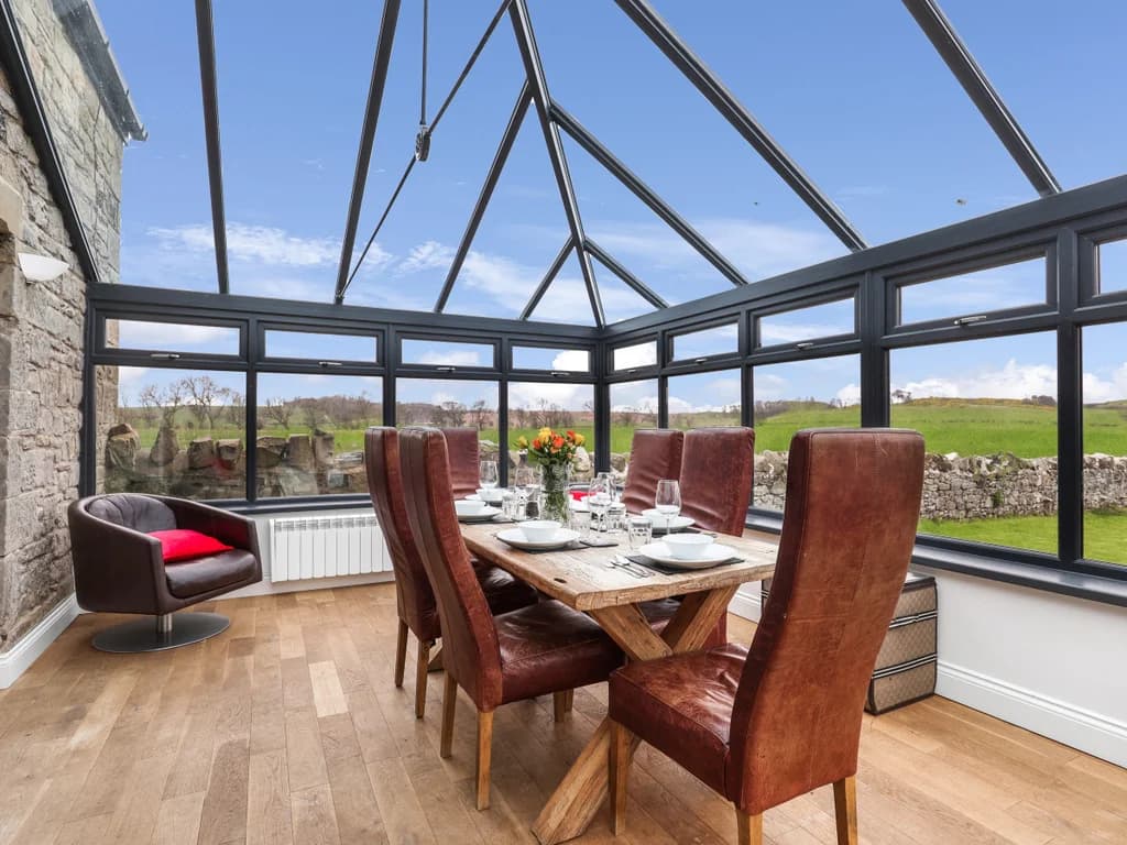 Conservatory dining room with panoramic countryside and garden views