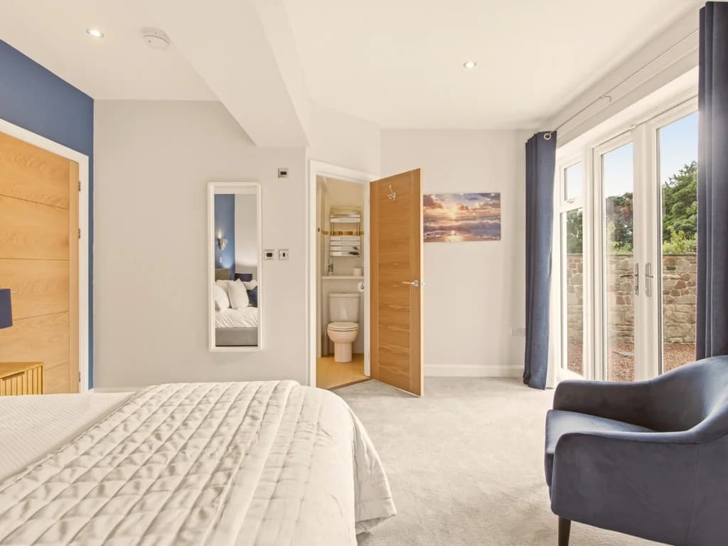 Spacious king bedroom with private en-suite and direct access to the garden