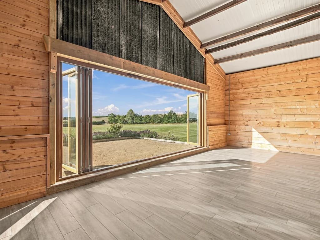 Wide folding doors opening the event space to countryside views