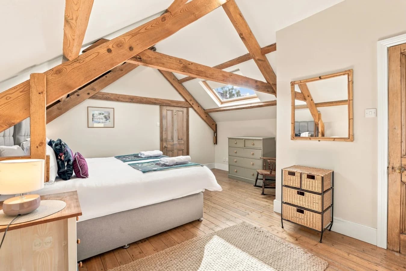 Super king bedroom with wooden floors and original timber beams