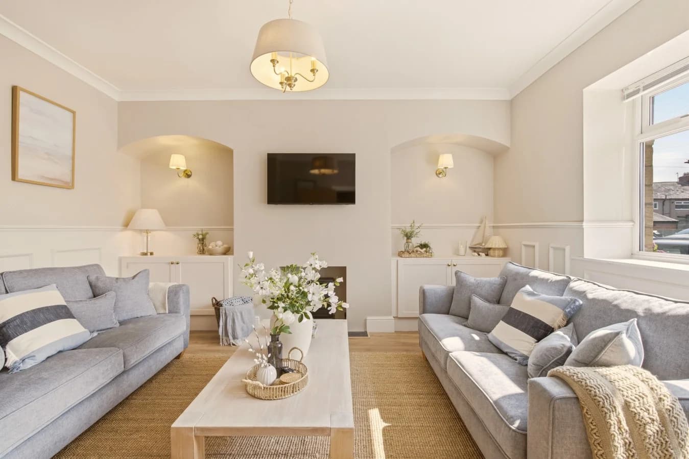 Grey lounge with half-height panelling and wall-mounted Smart TV.