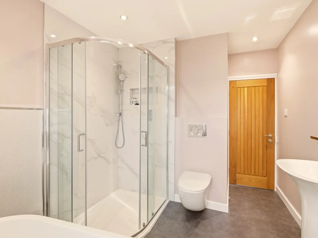 Contemporary family bathroom with walk-in shower, bath and modern fittings.