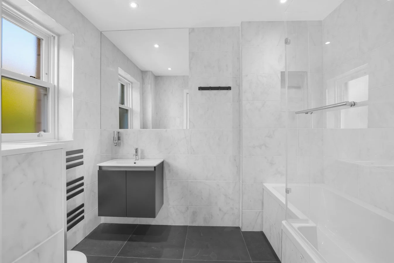 Family bathroom with bath, overhead shower and vanity unit