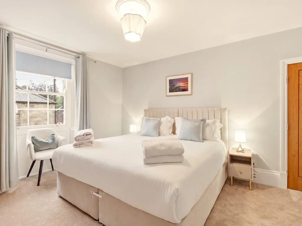 Spacious top-floor king bedroom with en-suite and built-in storage.