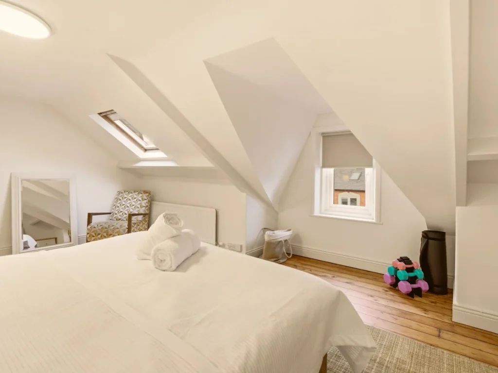 Spacious super king-size bedroom with skylight, mirror and light weights