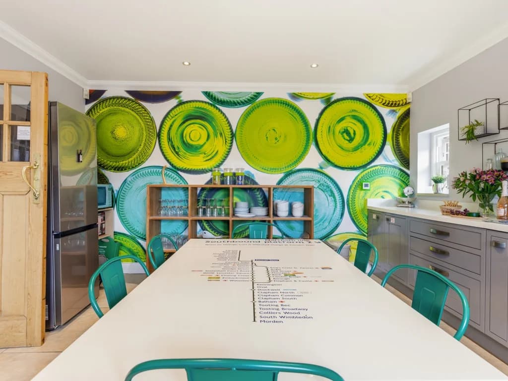 Family kitchen with shaker cabinets and London Tube-map dining table.
