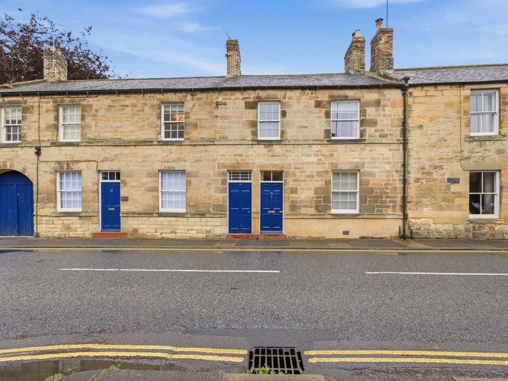 Traditional stone frontage of The Old Forge in the heart of Warkworth.