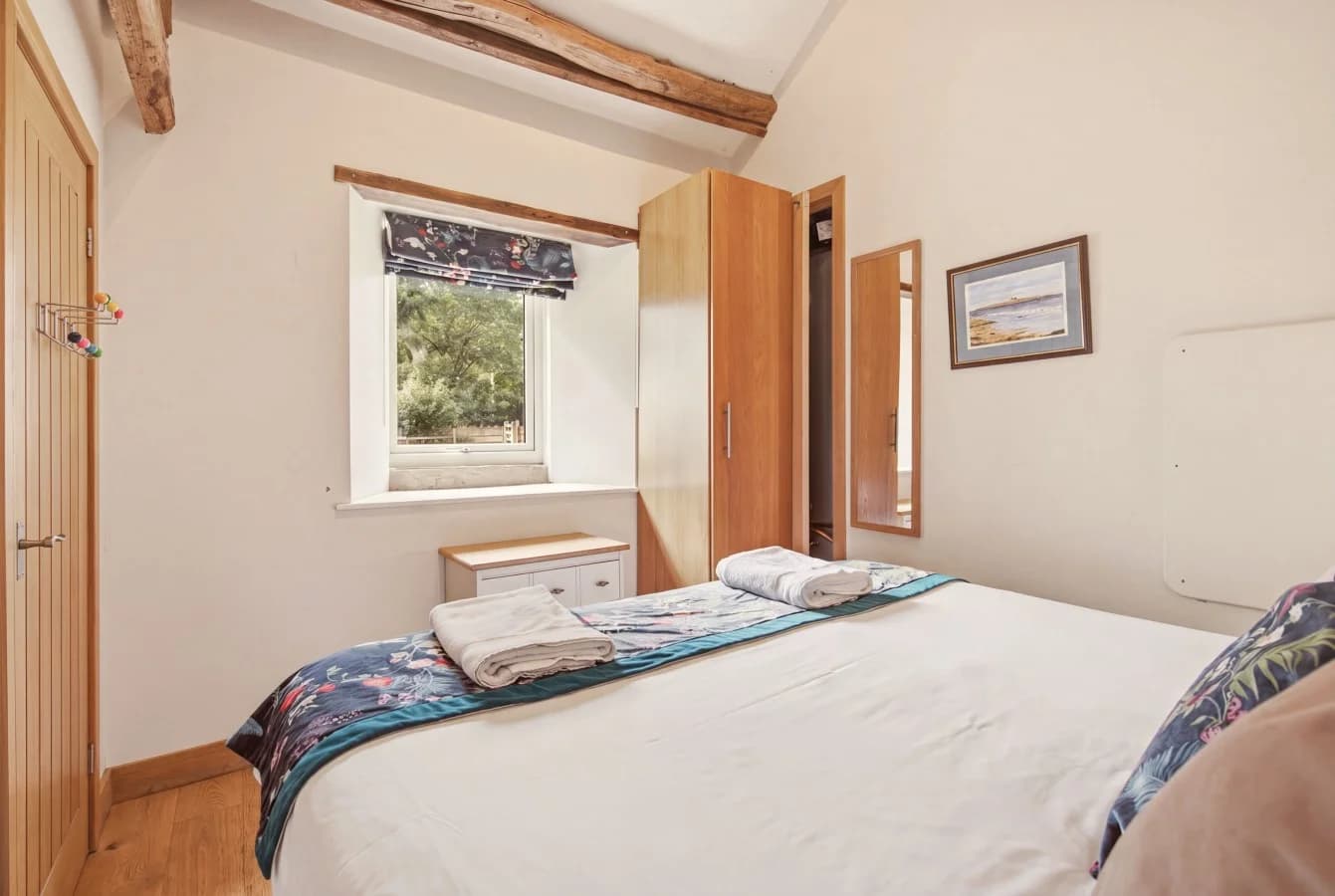 Bedroom with countryside window, wooden floors and timber details