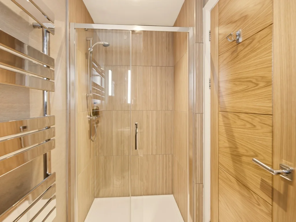 Stylish en-suite shower room with contemporary wood-effect wall finishes