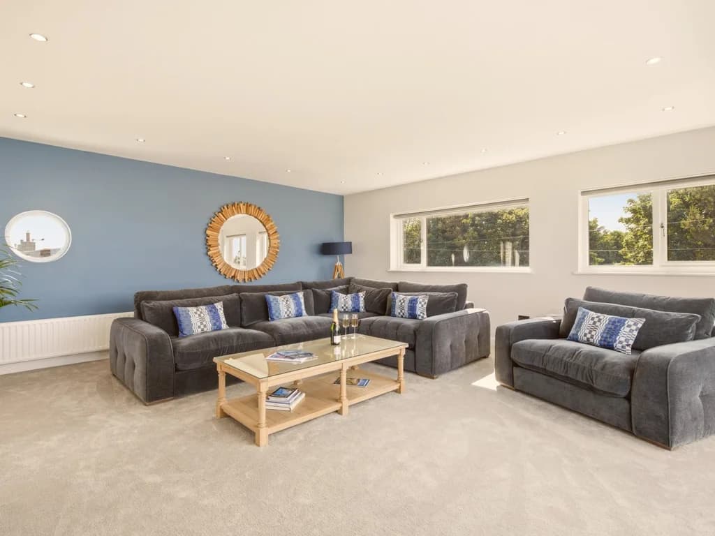 Spacious family lounge with comfortable seating and plenty of natural daylight