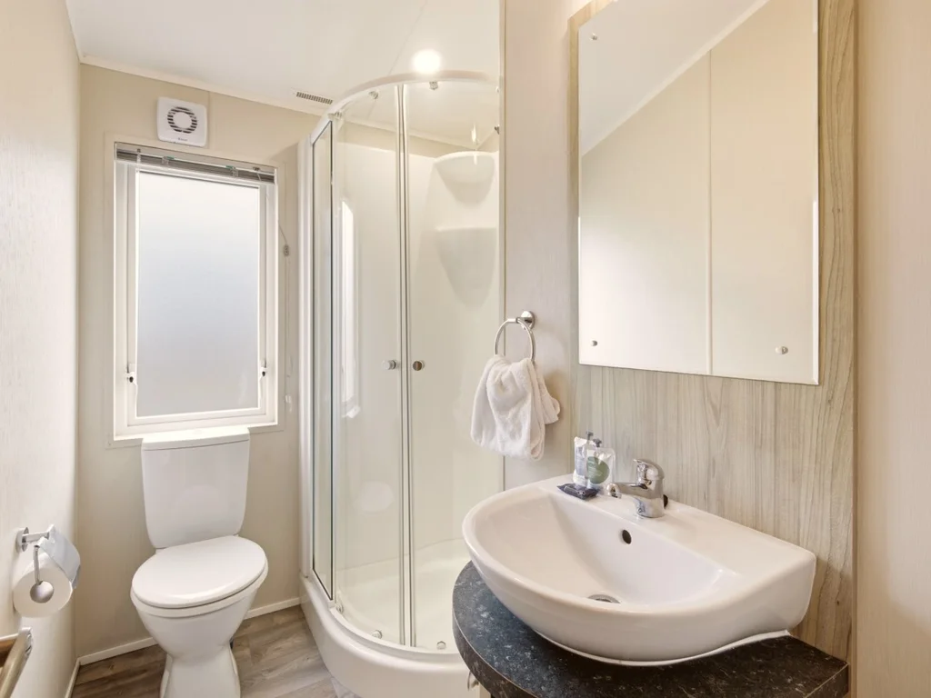 Modern shower room with curved enclosure, wash basin and WC