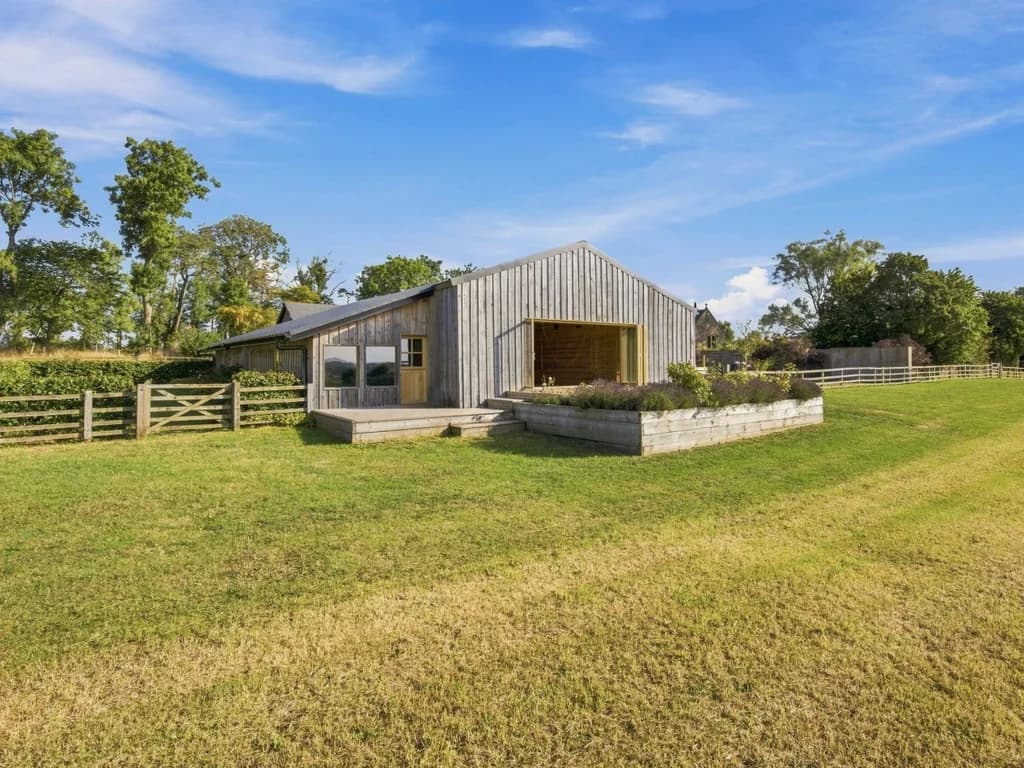 The Big Barn exterior surrounded by open lawns and mature trees