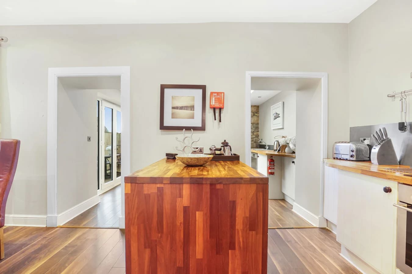 Open-plan kitchen with central island and oak flooring