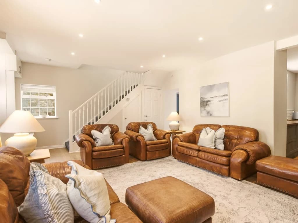 Spacious lounge with leather seating and open-plan layout.