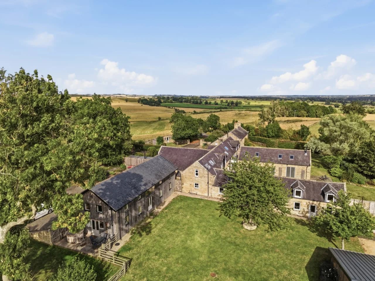 Aerial view of Roses Bower surrounded by rolling countryside