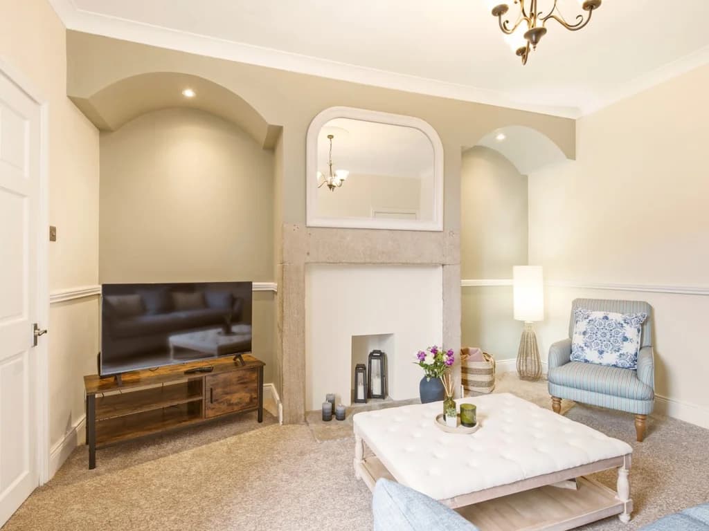 Stone fireplace with decorative alcoves and comfortable seating.
