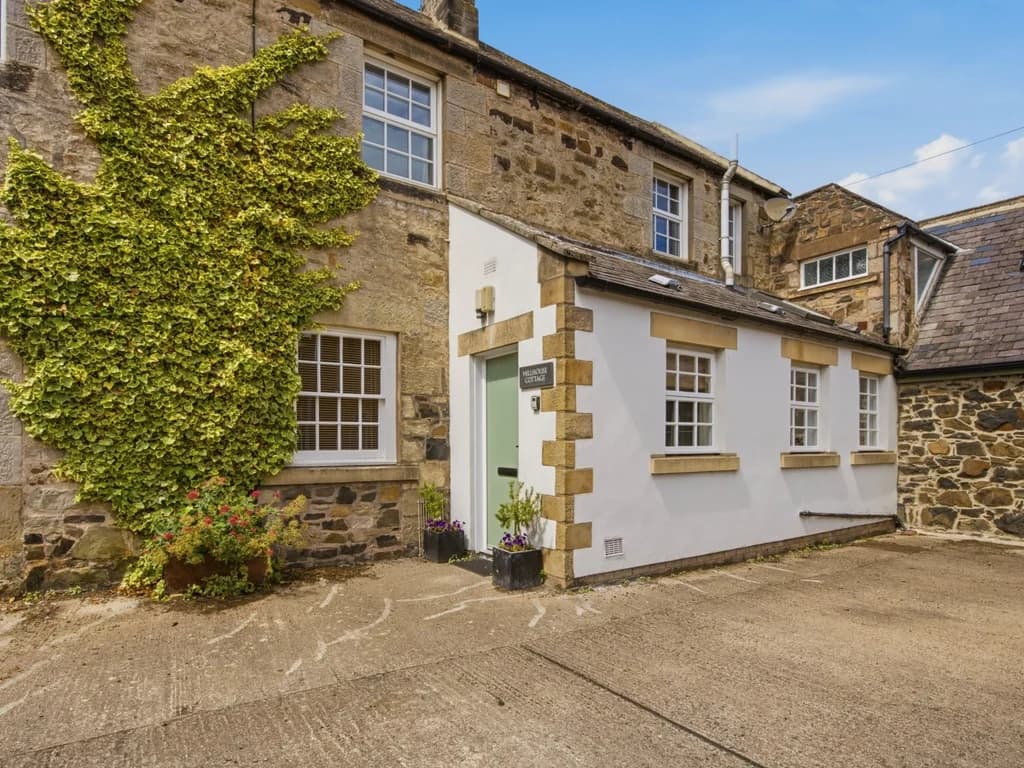 Characterful stone cottage with ivy-clad walls and private courtyard entrance