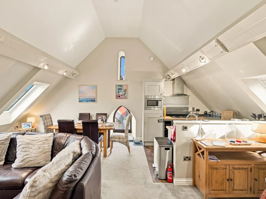 Bright open-plan living, dining and kitchen beneath vaulted ceilings.