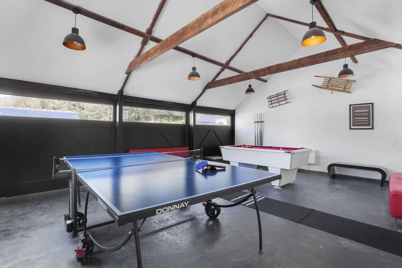 Shared games room with table tennis table, pool table and vaulted ceiling