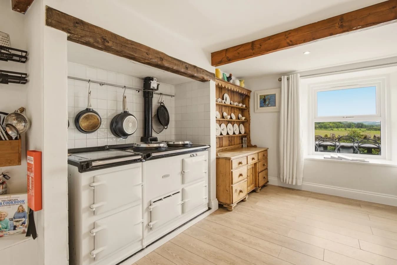Traditional AGA beneath exposed timber beams with countryside view