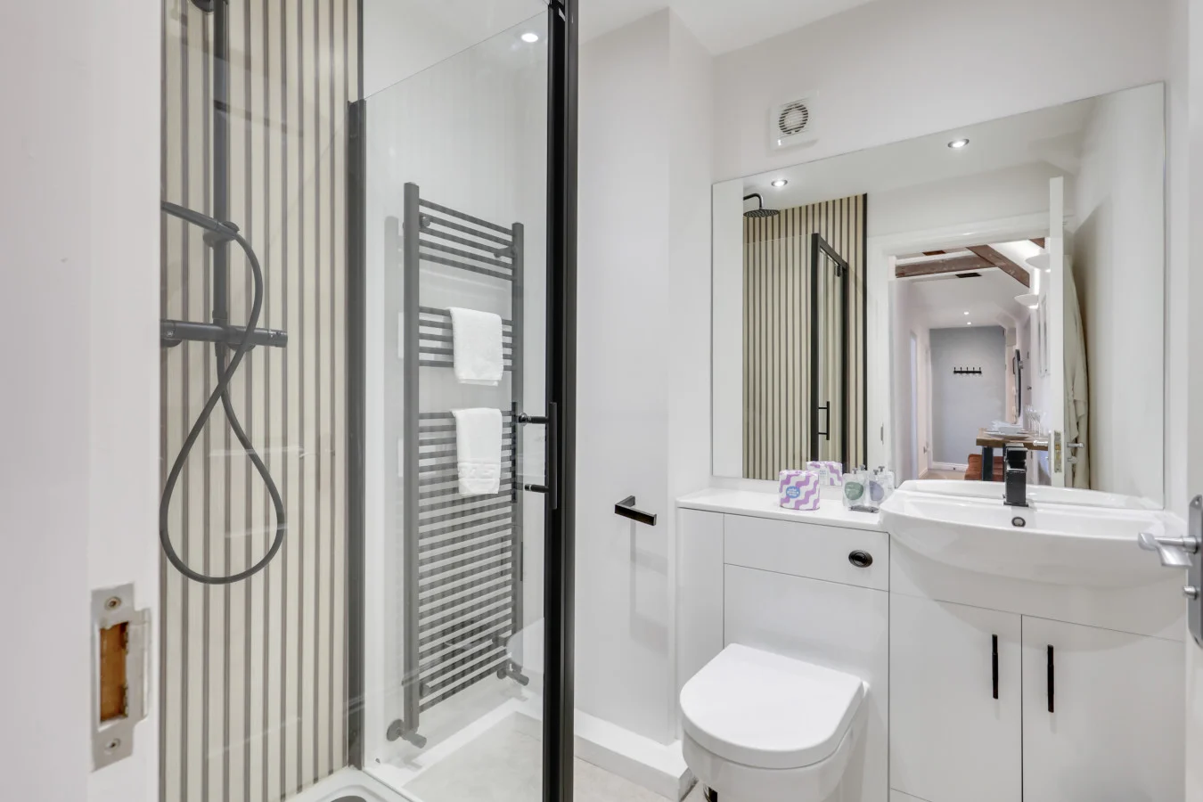 Contemporary shower room with striped tiling and matte black fittings