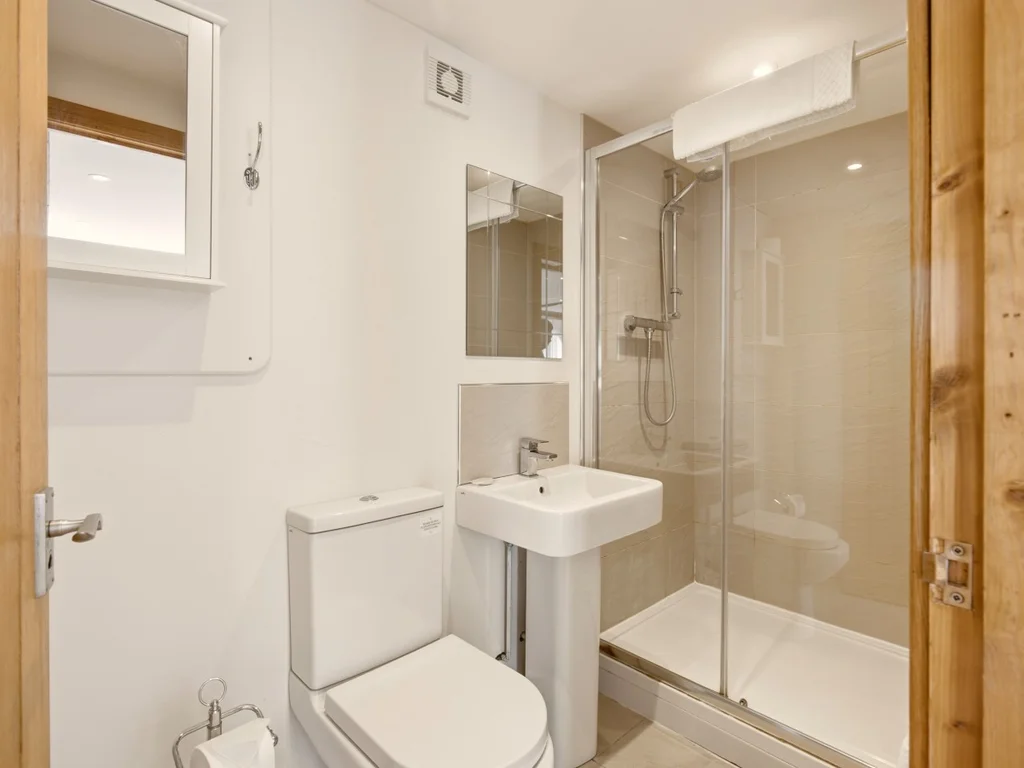 Shower room with glass enclosure, wash basin and WC