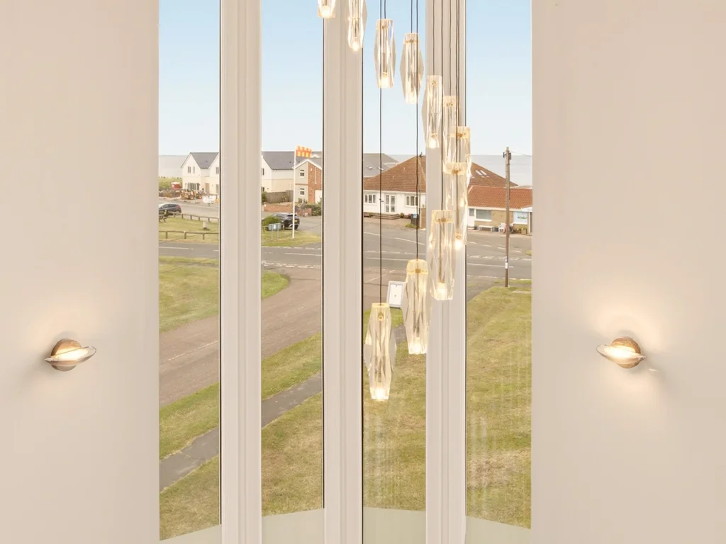 Feature staircase window filling the home with natural light and village views