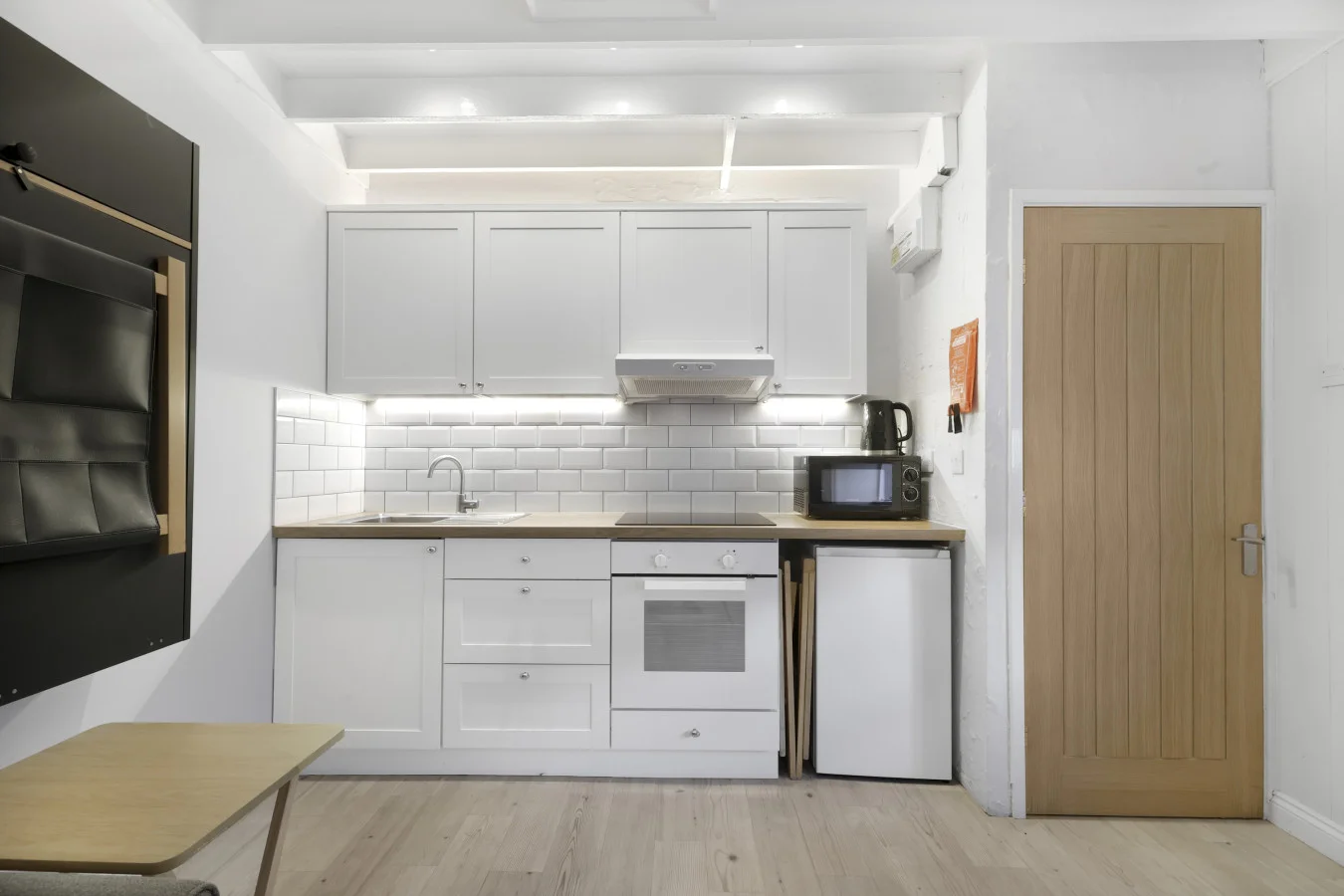 Fully equipped kitchen with shaker cabinetry and oak worktops