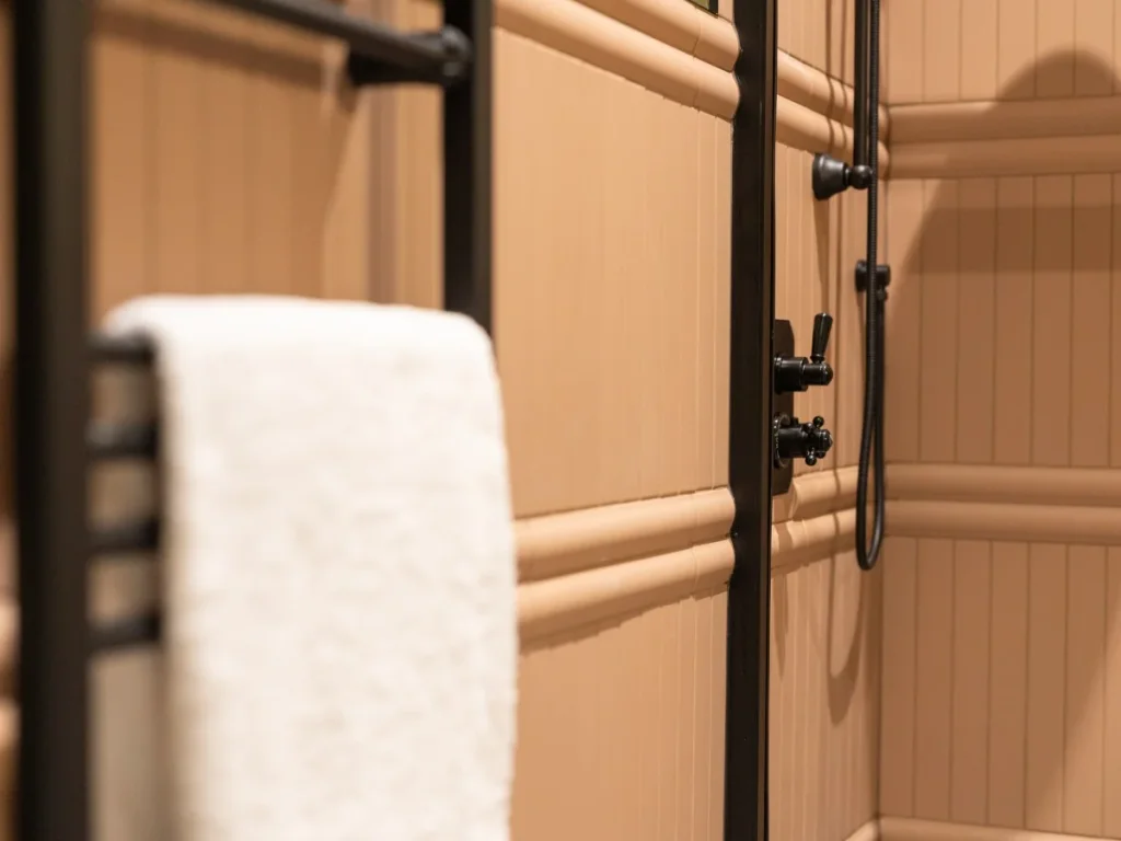 Close-up of the walk-in shower with black rainfall fittings