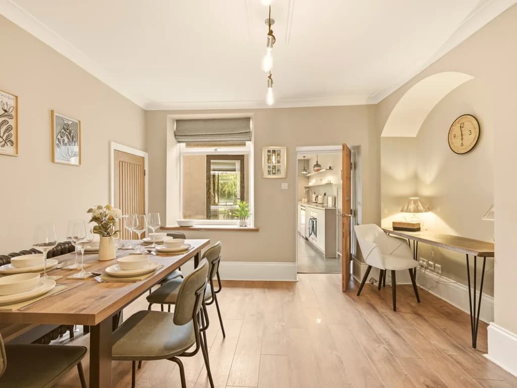 Spacious dining area with seating for six and access to the kitchen.