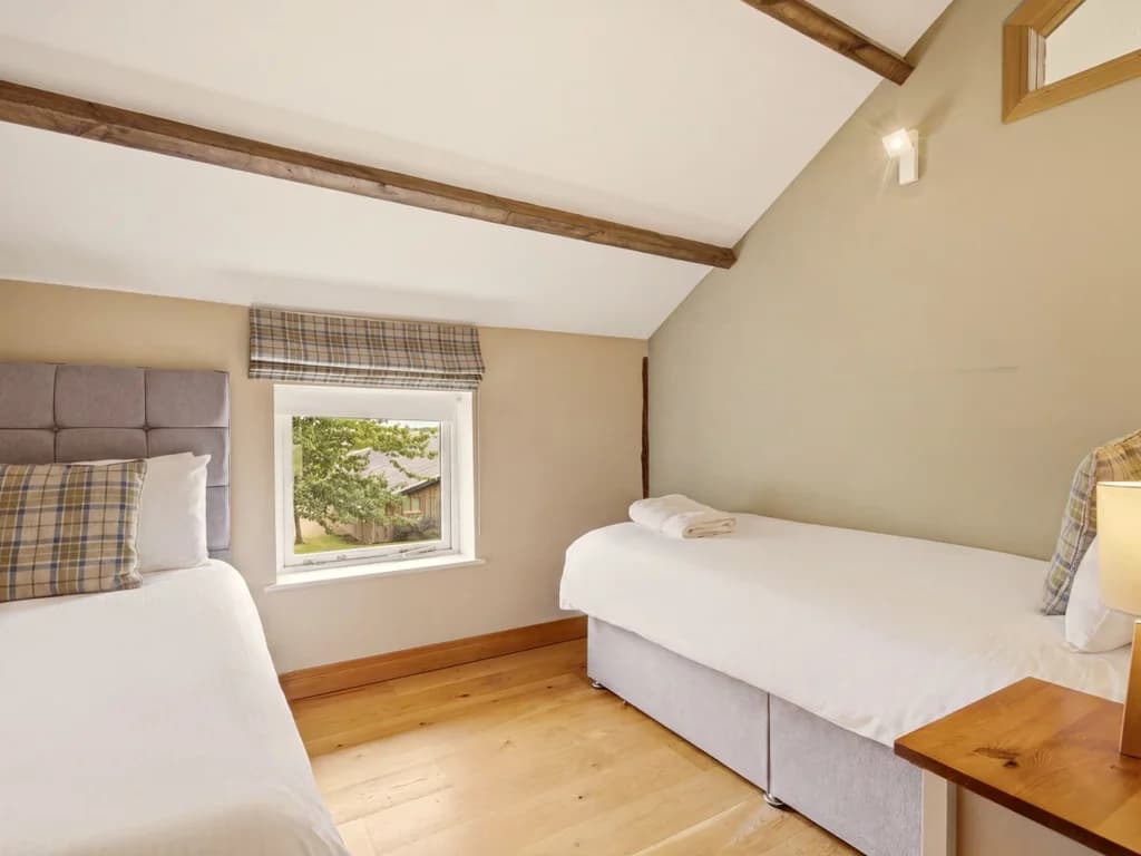 Twin beds with tartan accents and window overlooking the grounds