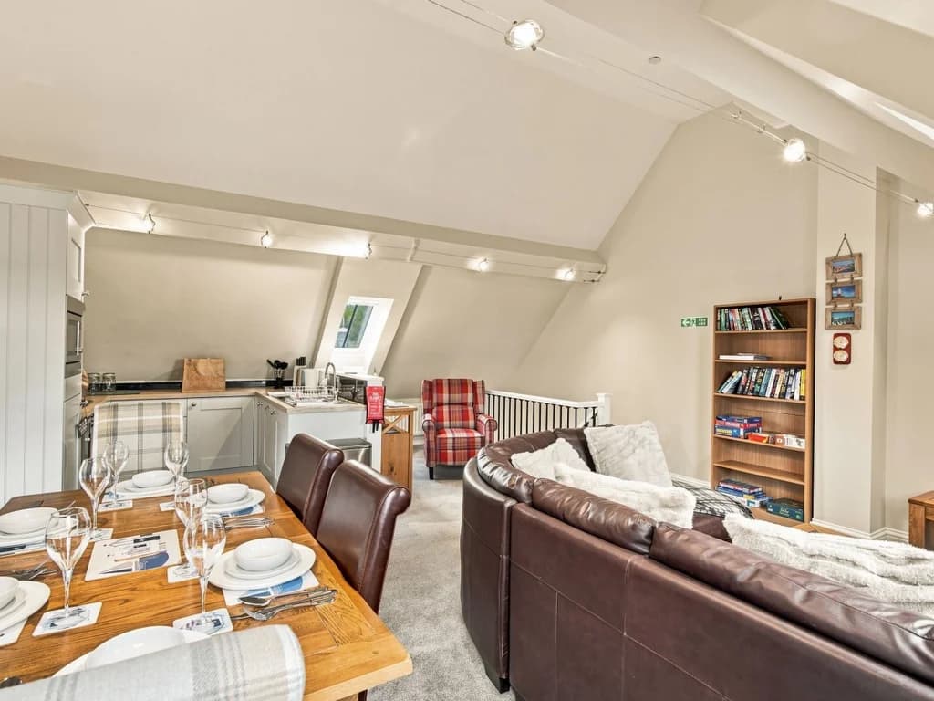 Spacious open-plan layout with dining area, lounge and fitted kitchen.
