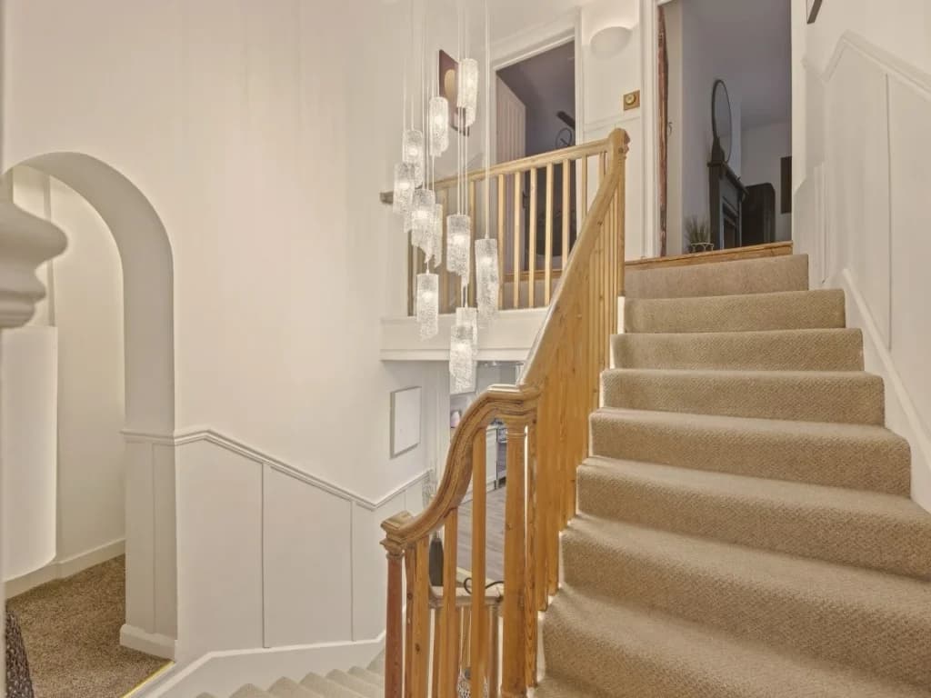 Carpeted staircase connecting Yule House's characterful multi-level layout.