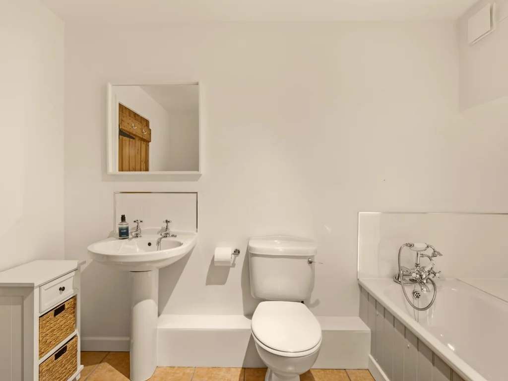 Ground-floor family bathroom with full-size bath, pedestal basin and WC