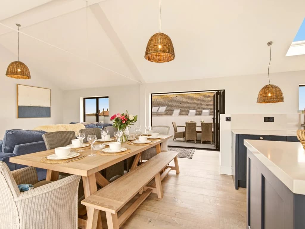 Open-plan dining area flowing seamlessly into the contemporary kitchen