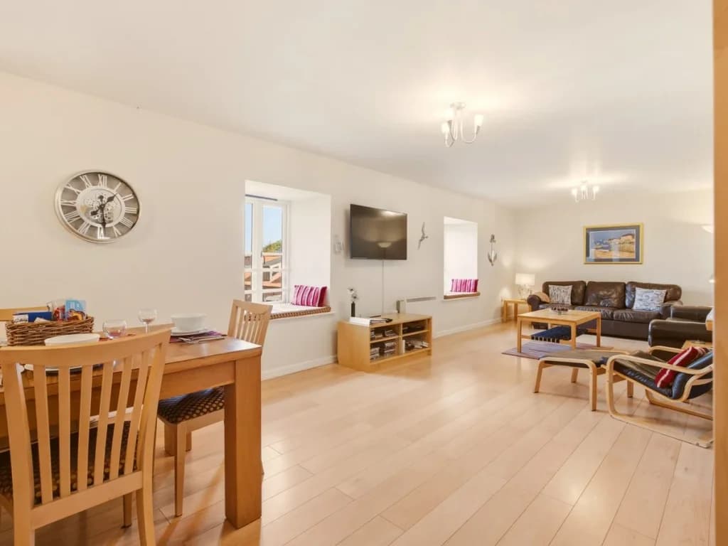 Open-plan dining and living area with bay views and comfortable seating