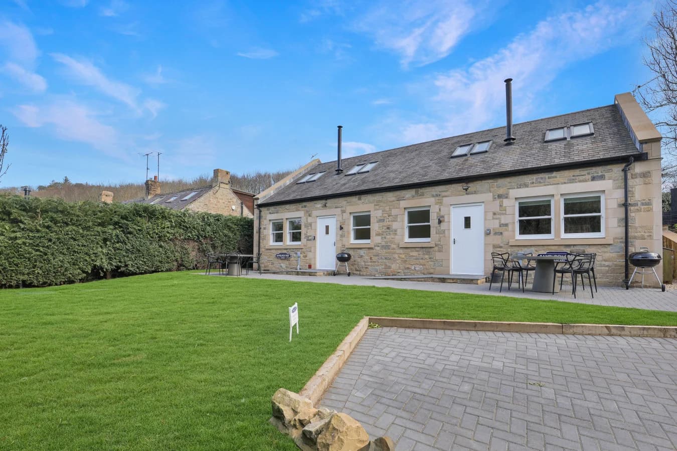 Stone-built cottage with shared lawn and paved patio