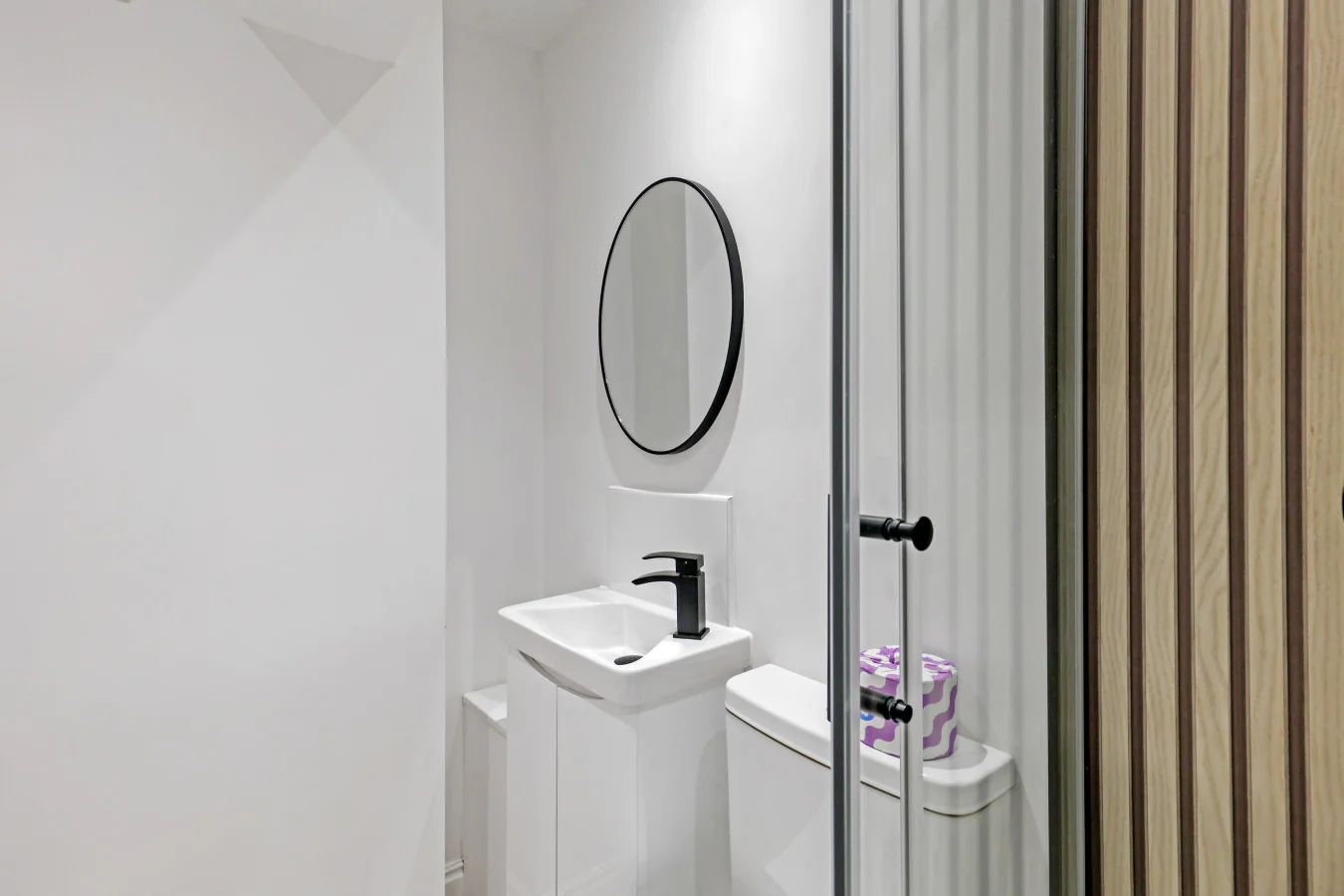 Contemporary shower room with minimalist fittings and striped screen