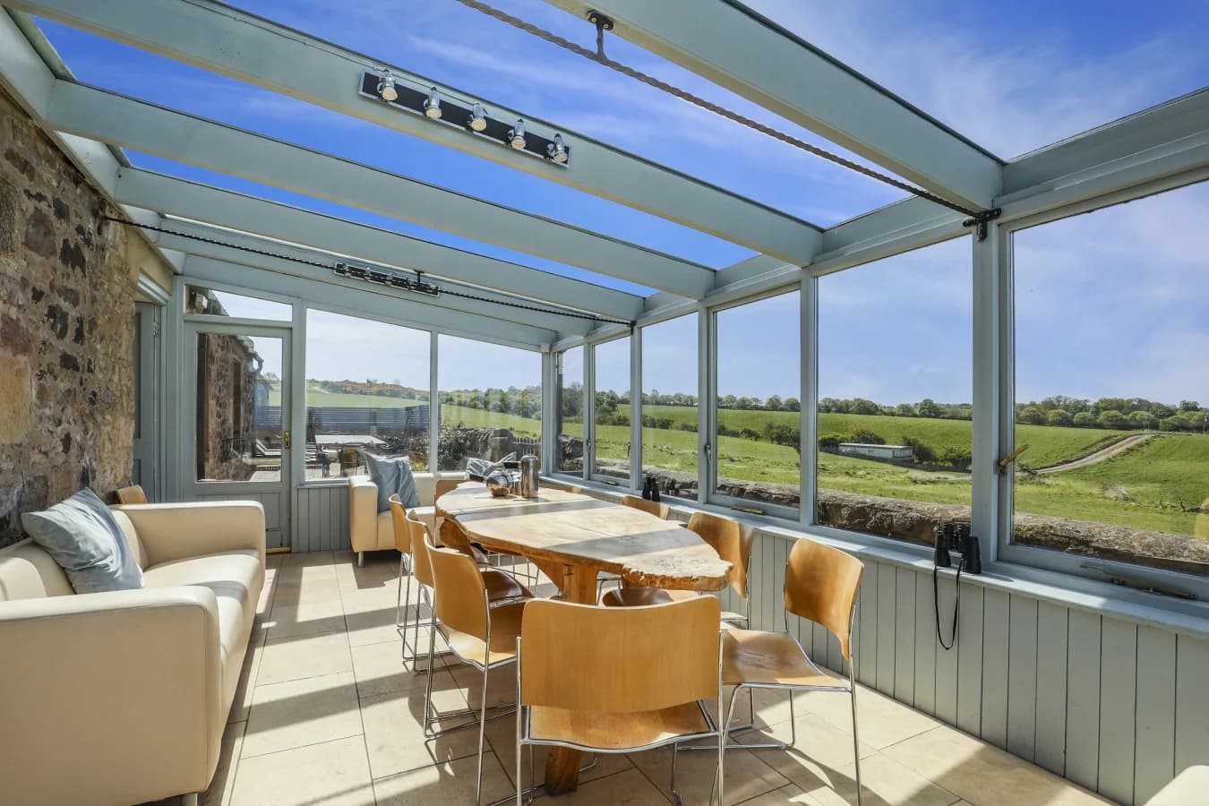 Conservatory dining and seating area overlooking the bay