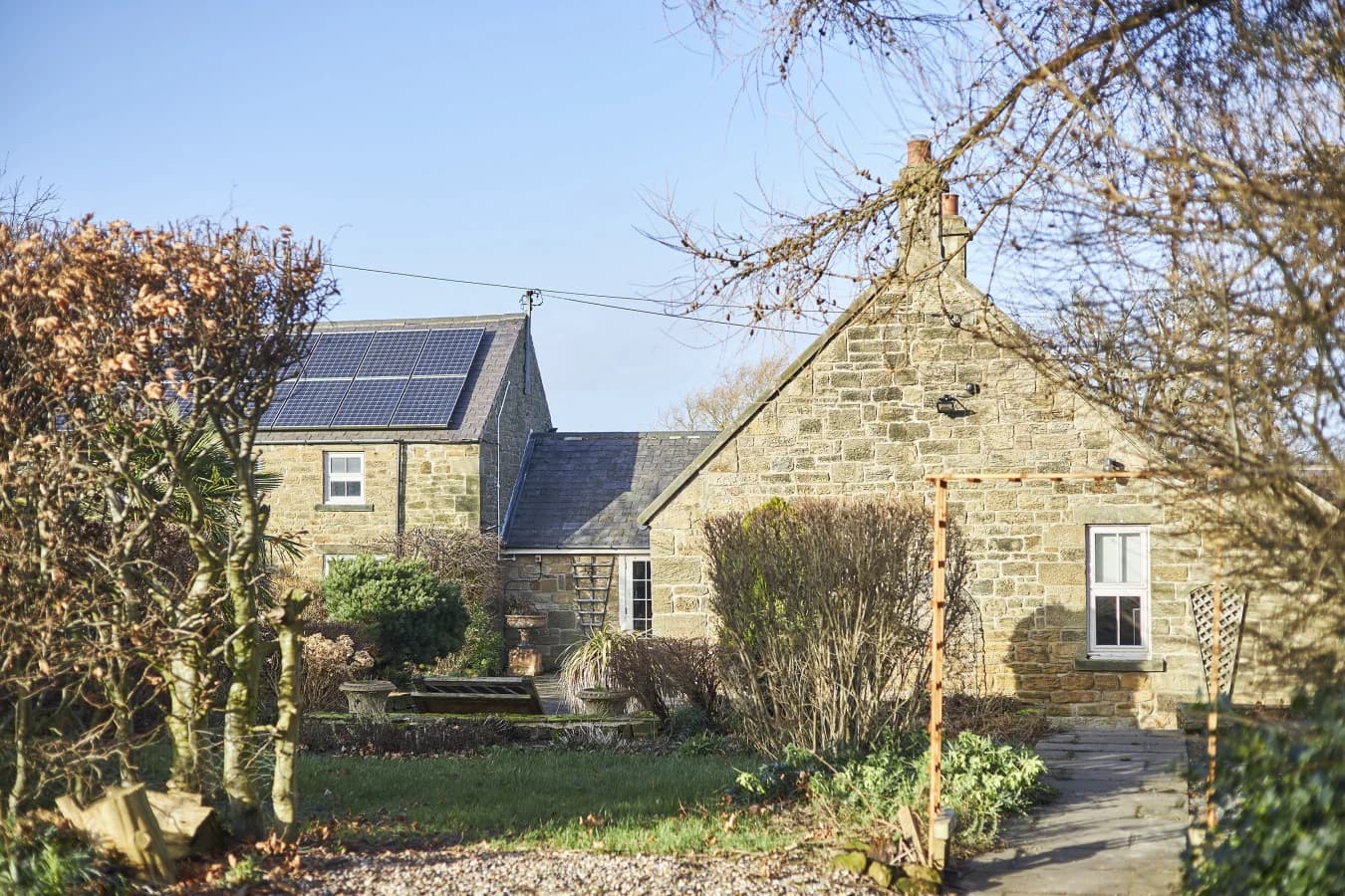 Traditional stone farmhouse nestled within private mature gardens