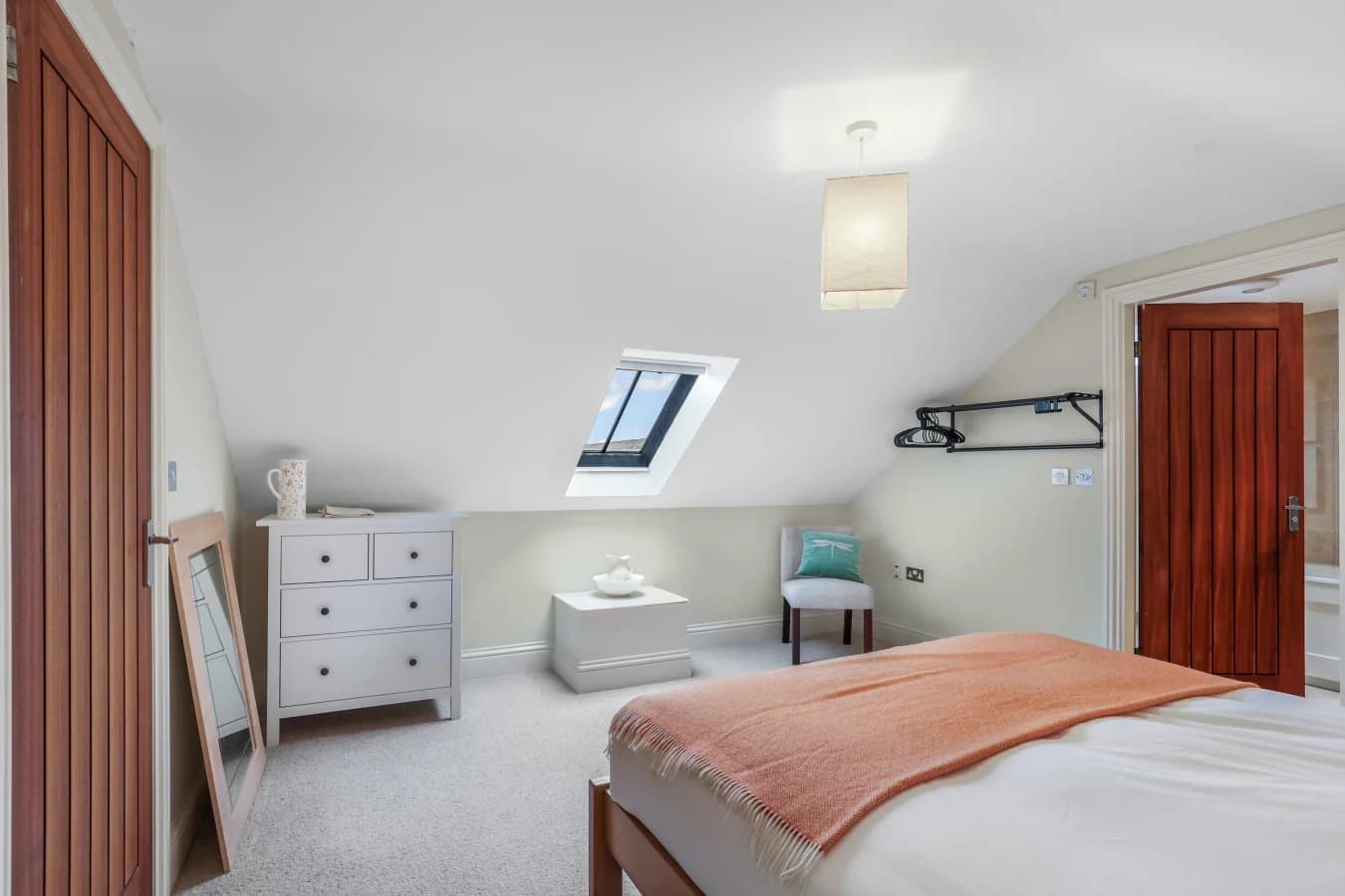 First-floor king bedroom with skylight and elegant furnishings
