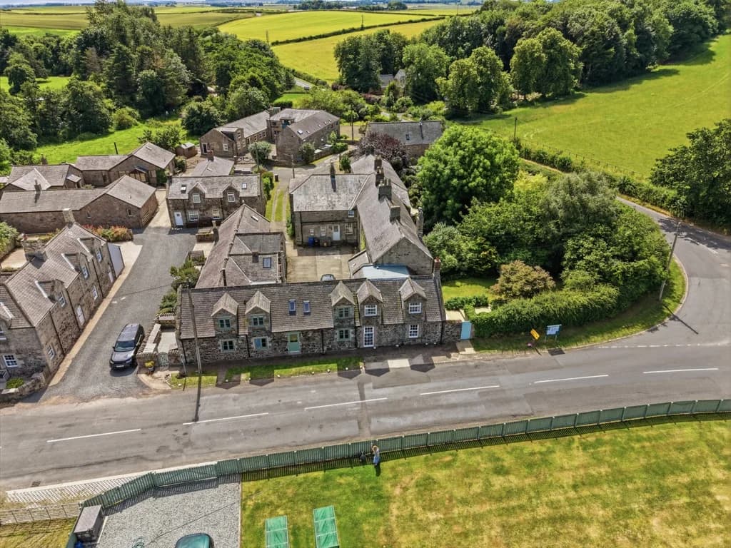 Bird's-eye view showcasing stone cottages and the charming Waren Mill hamlet