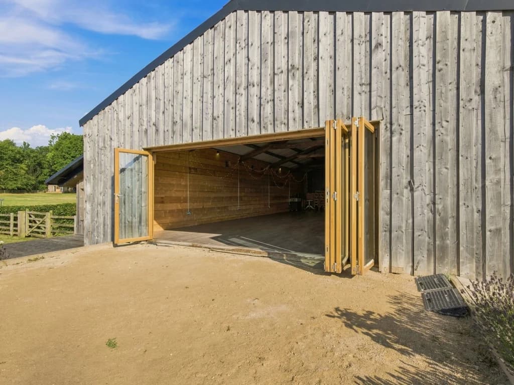 Wide folding barn doors providing direct access to the event space