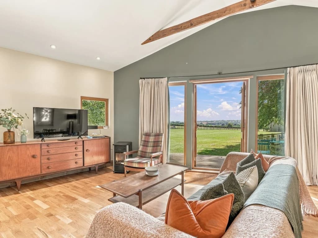 Living area with Smart TV and doors framing countryside views